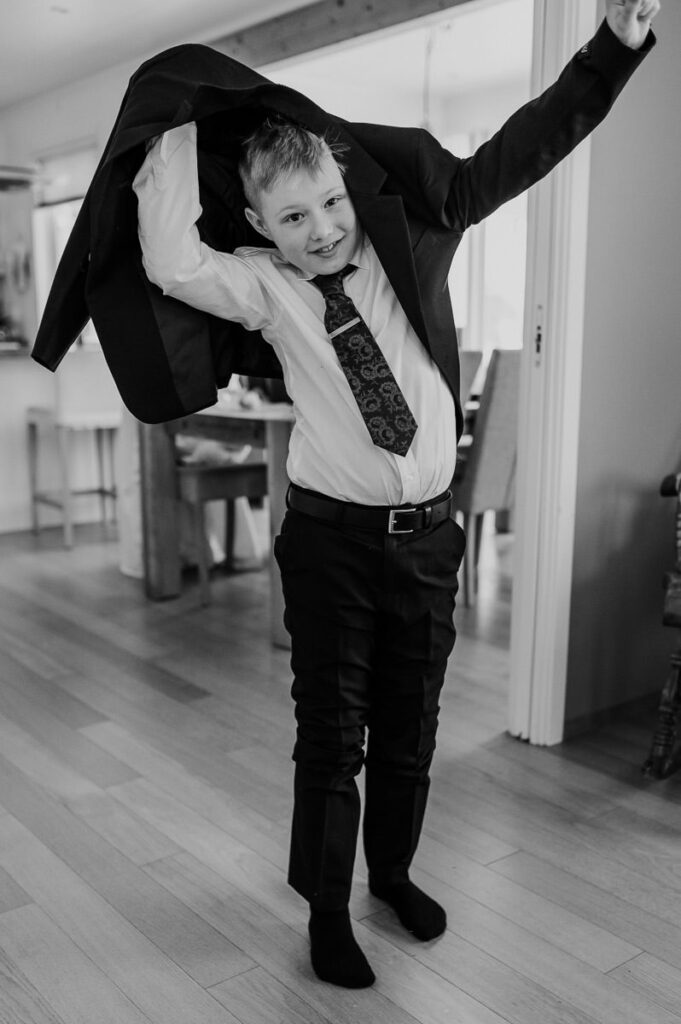 Bride and groom's son getting dressed for the wedding ceremony