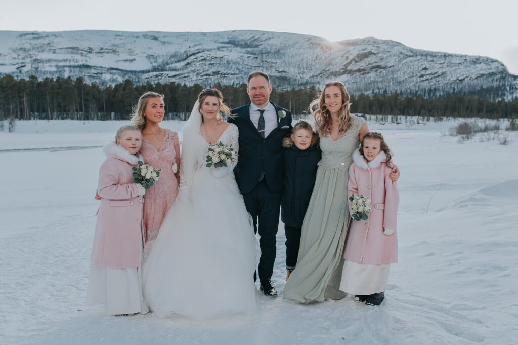 Formal portraits of the bride and groom and their kids on the day of their winter wedding in Alta Norway