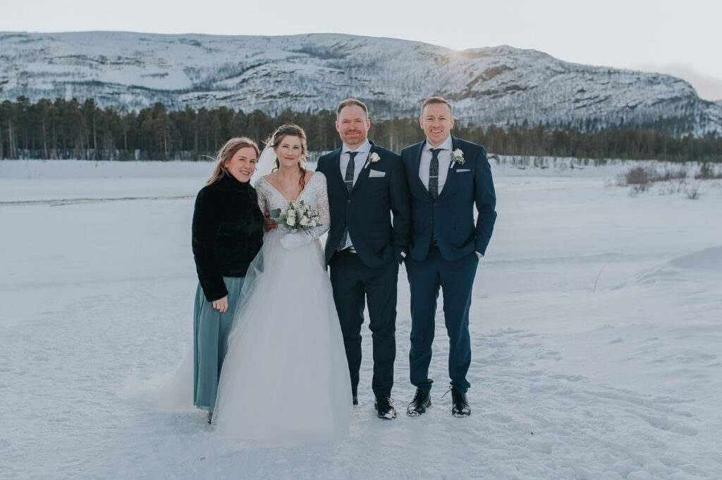Formal portraits of the bride and groom and their bridesmaid and groomsman on the day of their winter wedding in Alta Norway