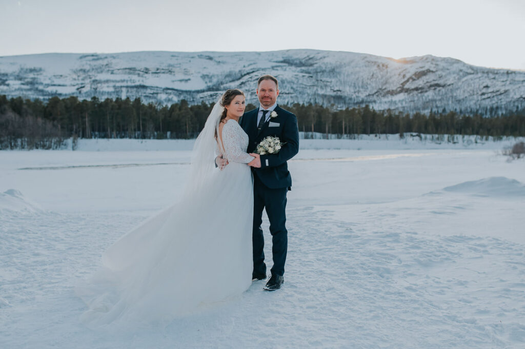Portraits of the bride and groom and on the day of their winter wedding in Alta Norway among beautiful winter landscapes