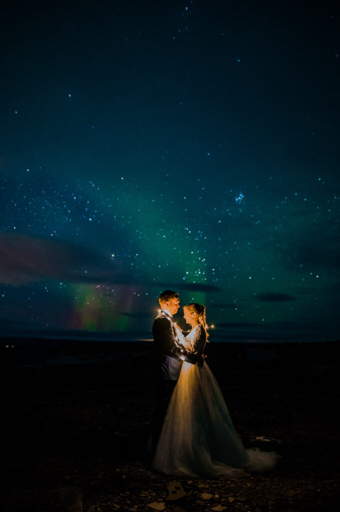 Romantic Bride and groom portraits under the northern lights Aurora Borealis - wedding elopement photos in Alta Norway