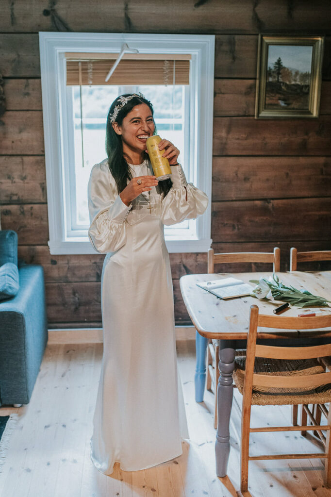Happy bride drinking beer in a cabin in Loen Western Norway