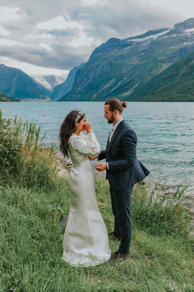 Bride and groom crying during their intimate elopement ceremony by the glacier lake in Loen, Stryn 