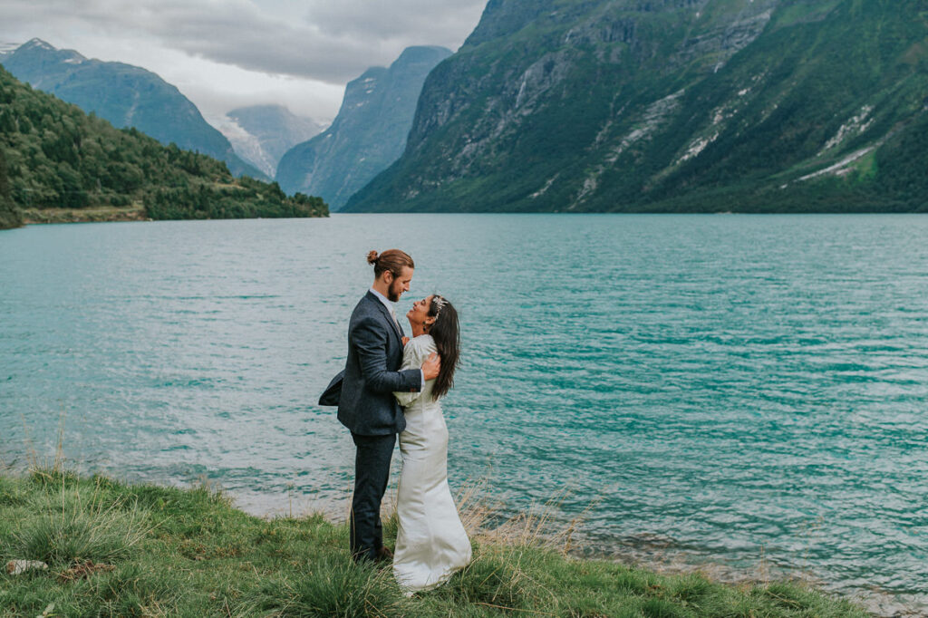 Beautiful bride and groom portrait in front of Lovatnet lake in Loen on their elopement day