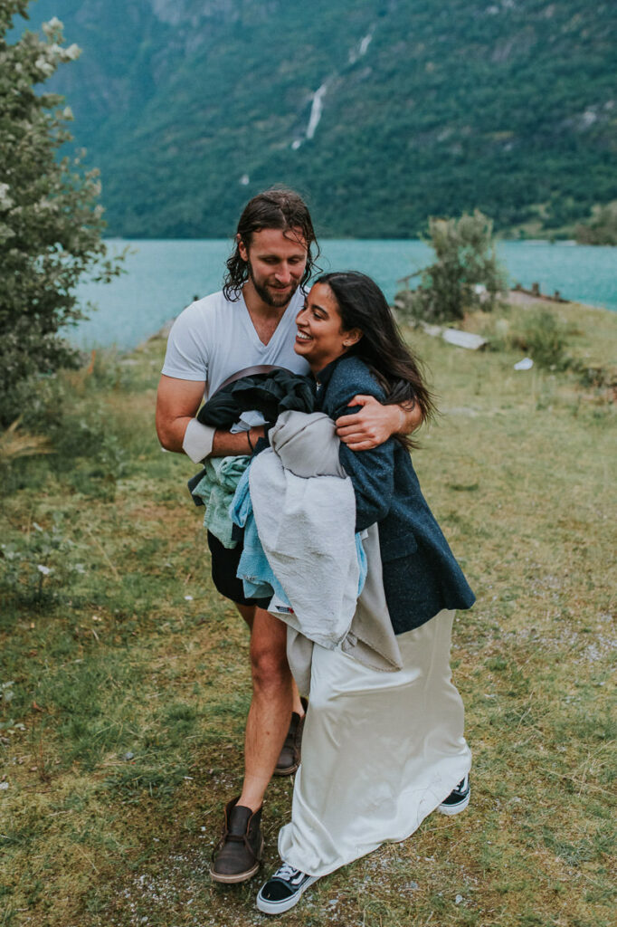 Bride and groom hugging after the swimming tour on their adventure wedding day in Stryn Western Norway