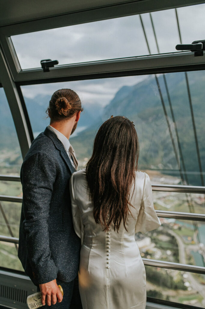 Bride and groom taking Loen Skylift up to the mountains on the day of their elopement in Loen, Stryn