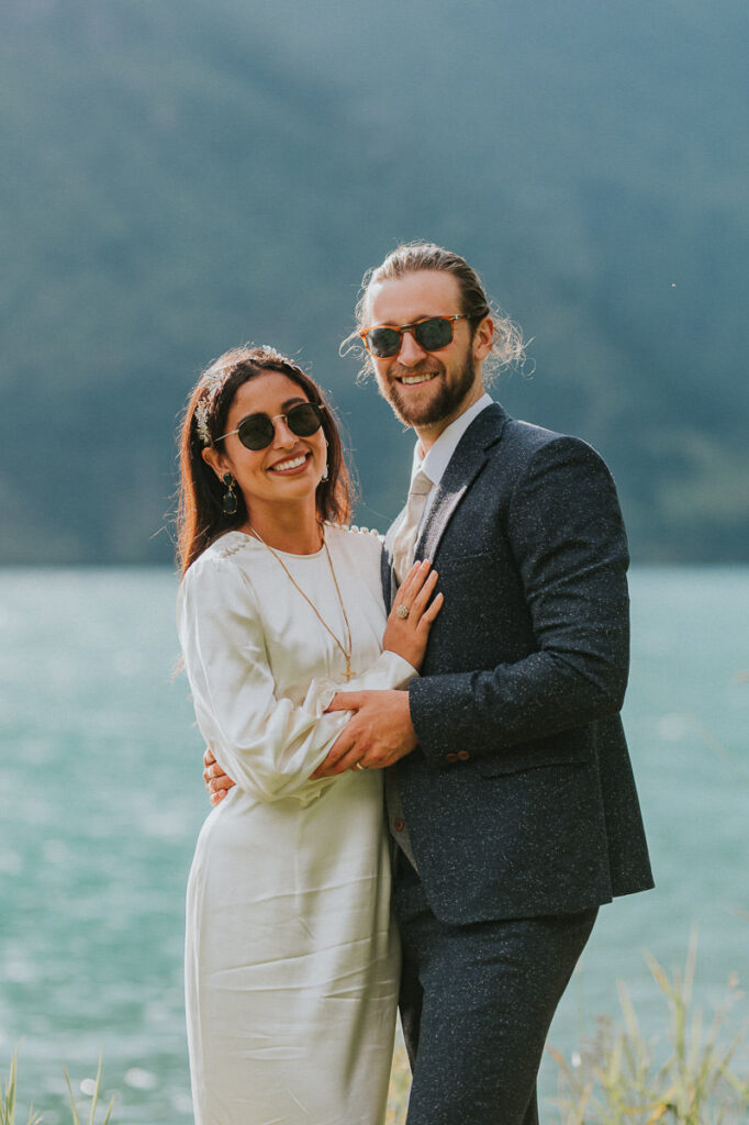Bride and groom portrait on a sunny day in Loen, Western Norway. Both are wearing sunglasses and smiling
