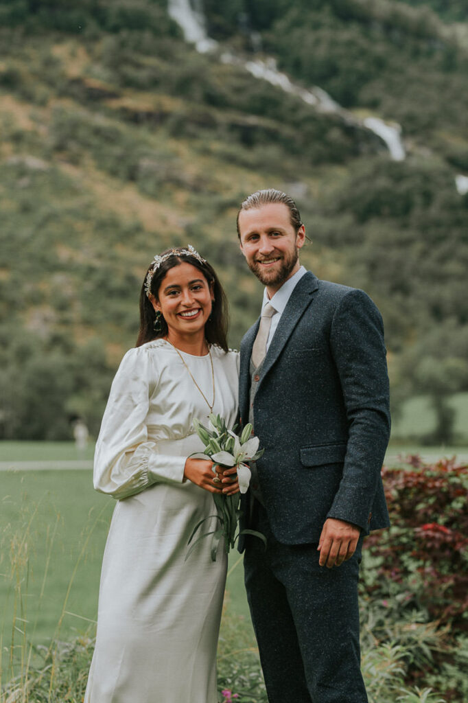 Bride and groom portrait outdoors in front of high mountains and beautiful norwegian nature