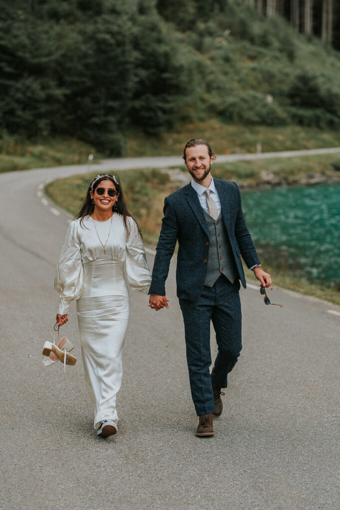 Bride and groom portrait on a sunny day in Loen, Western Norway. Bride is wearing sunglasses and smiling