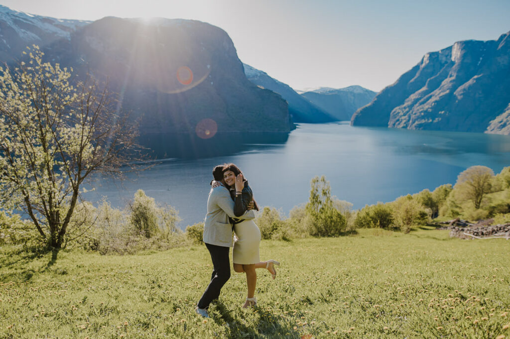 A happy couple just got engaged and the girl is showing off her engagement ring in front of a beautiful scenery in Aurland, Western Norway
