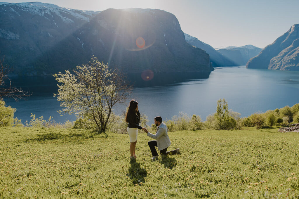 Surprise fjord proposal in Aurland Western Norway - a guy standing on his knee and proposing to his girlfriend in front of a spectacular view to Aurlandsfjord in Norway