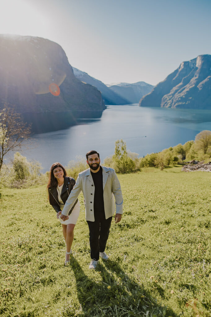 A happy couple just had a surprise fjord proposal among beautiful scenery in Aurland, Western Norway and are now ready for their adventure engagement photo session by the fjords