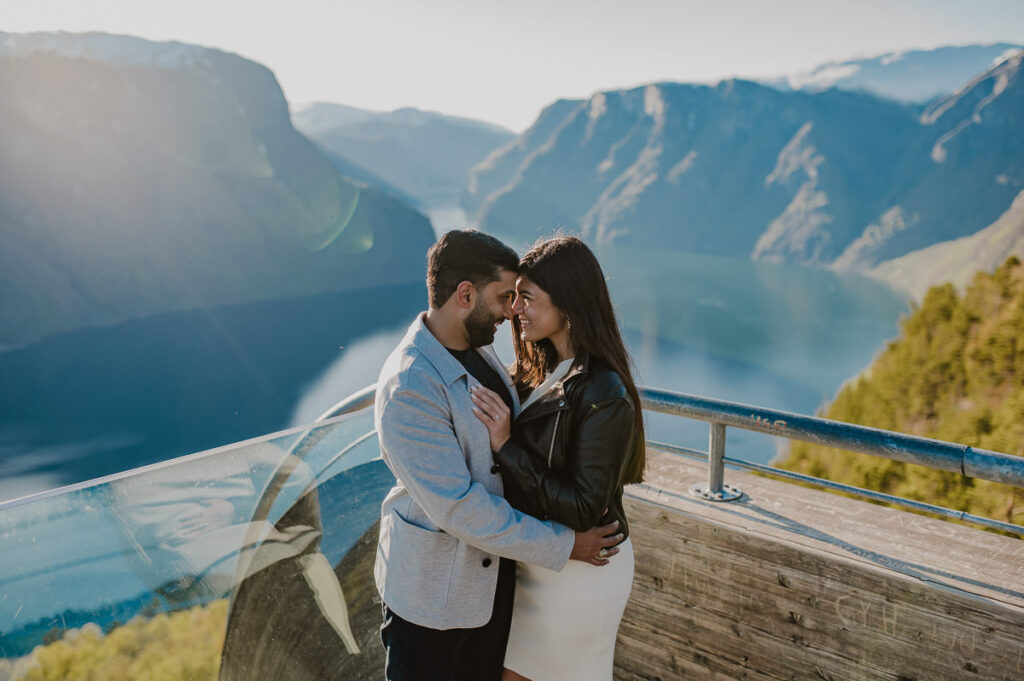 Beautiful couple hugging and kissing on Stegastein Viewpoint in Aurland Western Norway