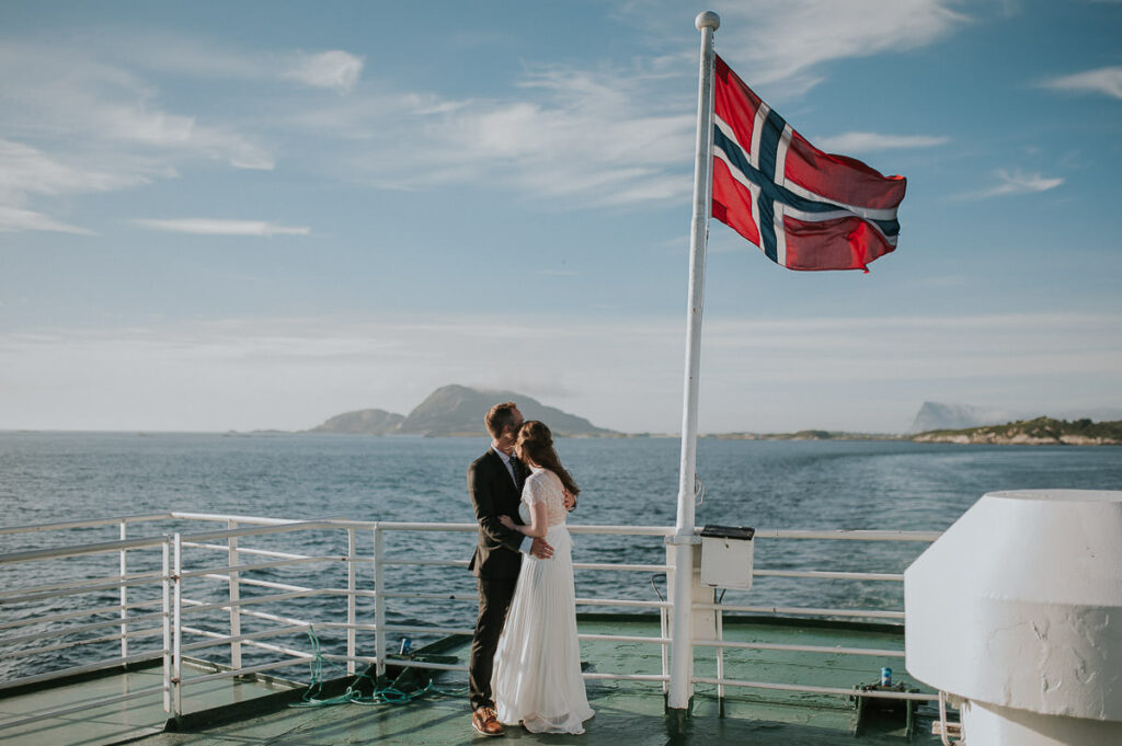Bride and groom on a ferry from Sommarøy to Senja on the day of their elopement in Northern Norway