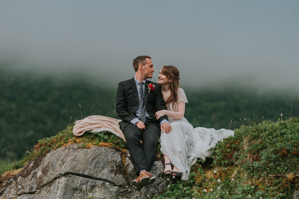 Bride and groom enjoying great foggy views of Senja island on the day of their elopement