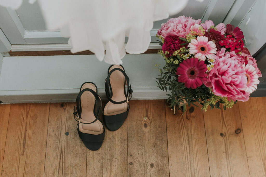 Bridal shoes and pink wedding bouquet