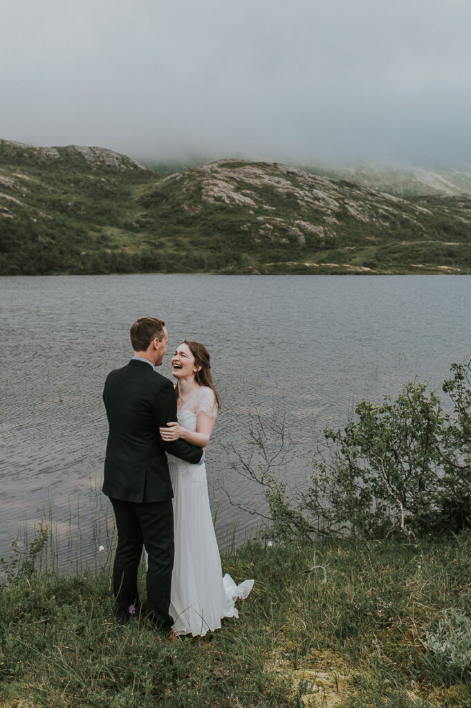 Bride and groom portrait in a moody cloudy landscape