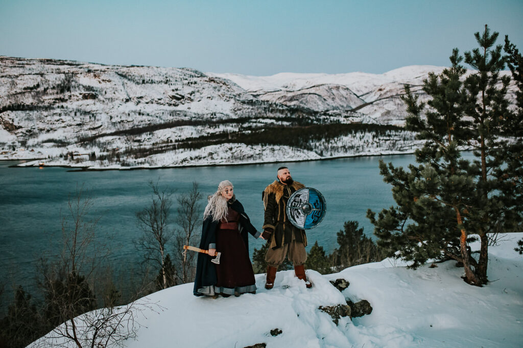 Viking couple posing in front of a beautiful winter landscape in Alta Norway