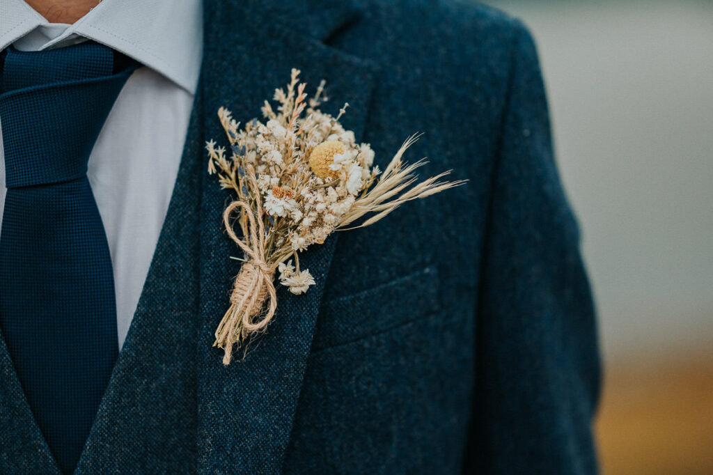 Boutonniere in yellow golden tones made out of dried flowers