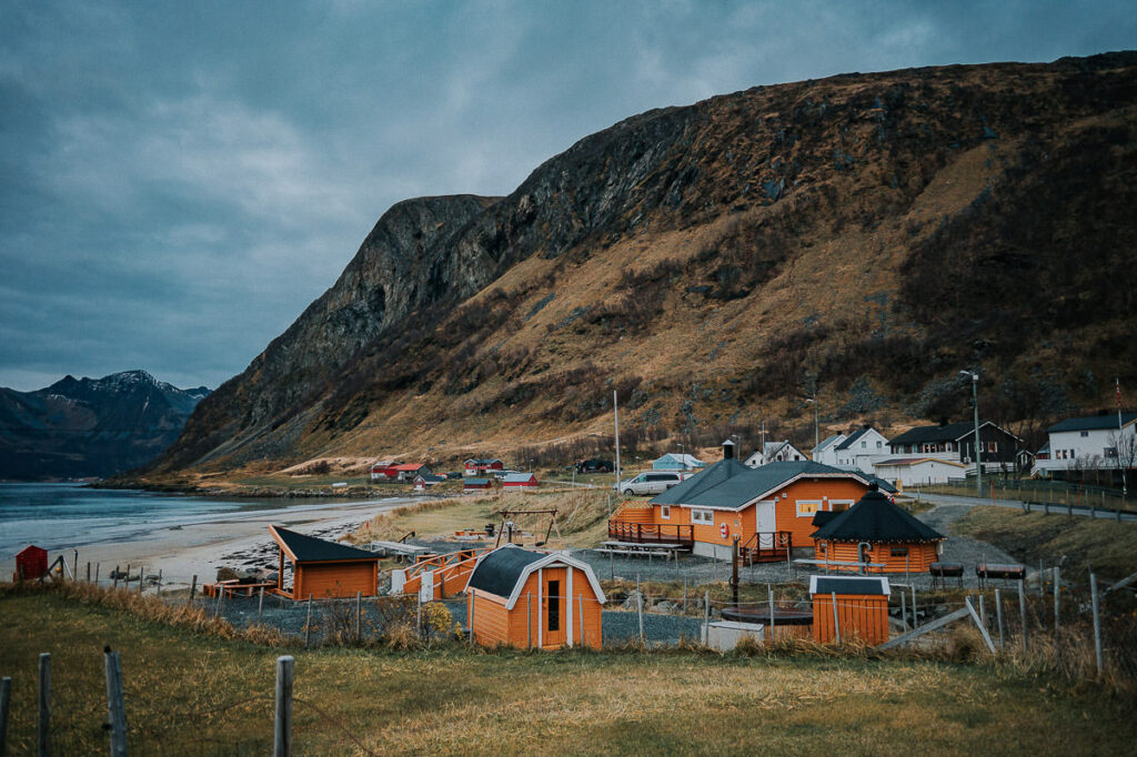 Yellow orange cabins and huts on a beach in Tromsø