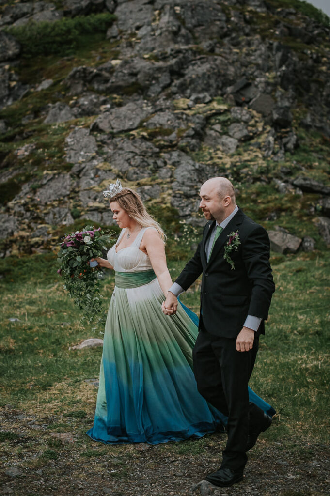 Bride and groom holding hands and walking to the ceremony spot on their elopement day