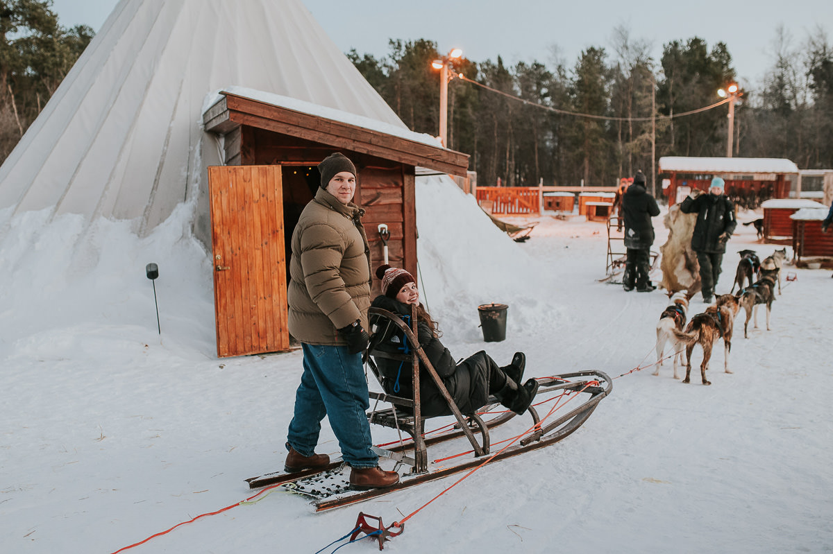 A couple on a dogsled ready to do dogsledding in Norway