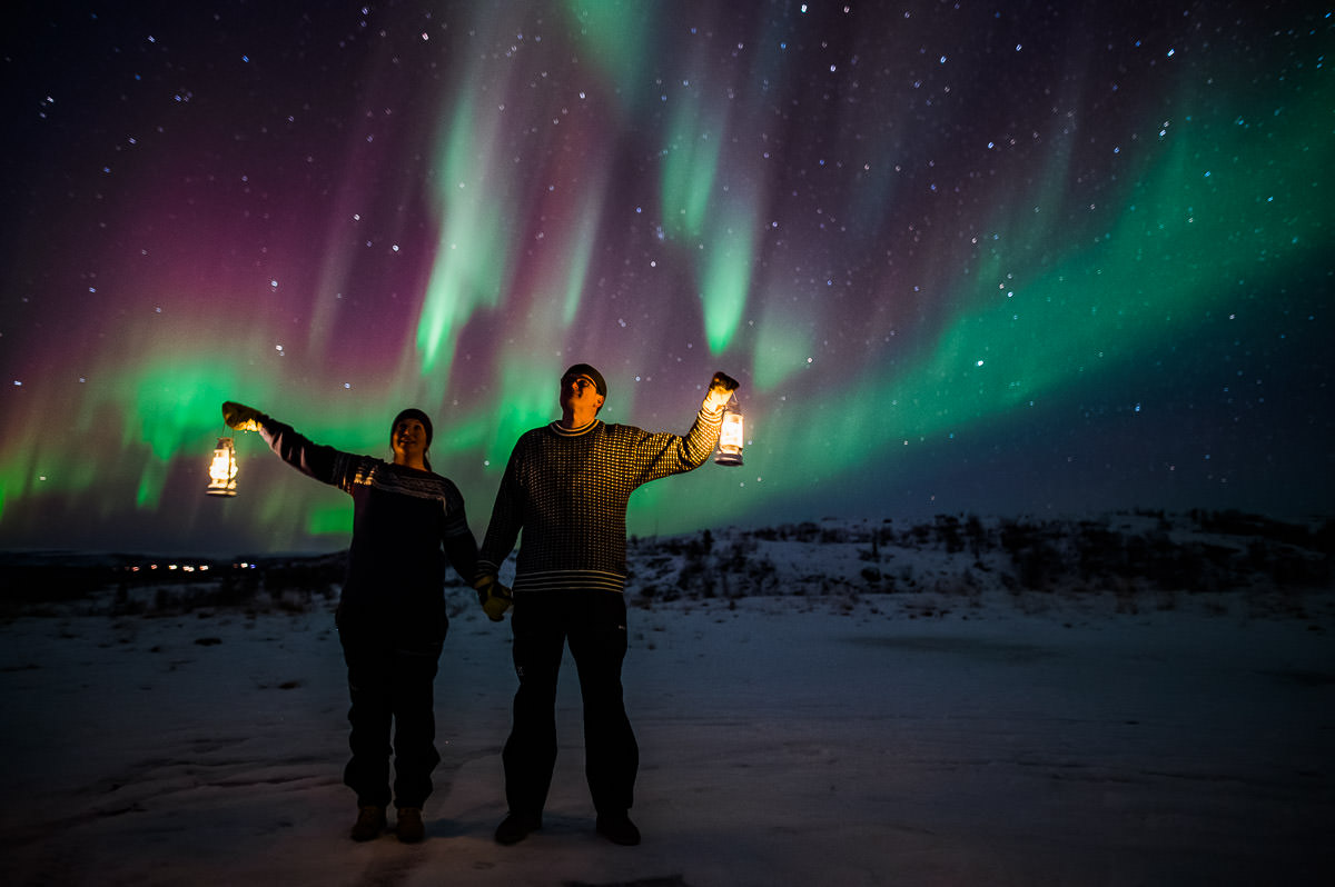 A couple watching a great northern lights show in Alta Norway