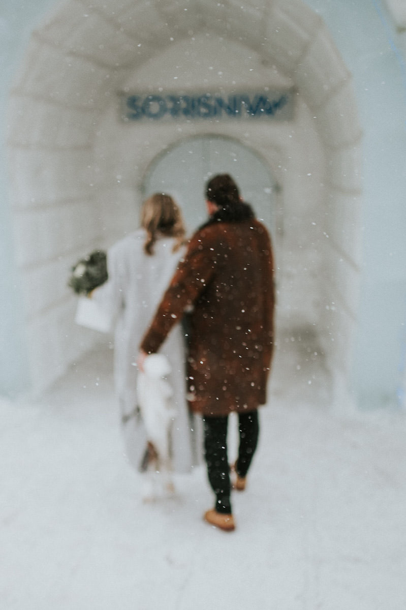 Bride and groom walking in the ice hotel in Alta Norway