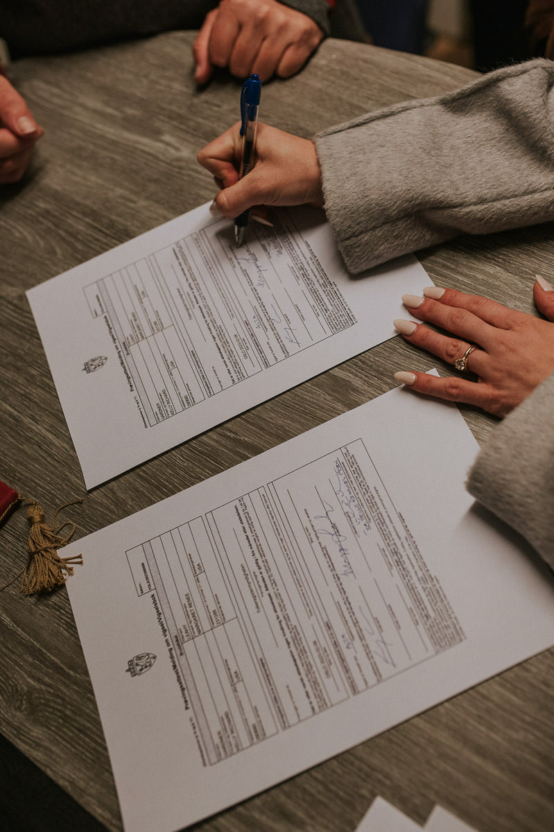 Bride and groom signing the papers after their legally binding elopement wedding in Alta Norway