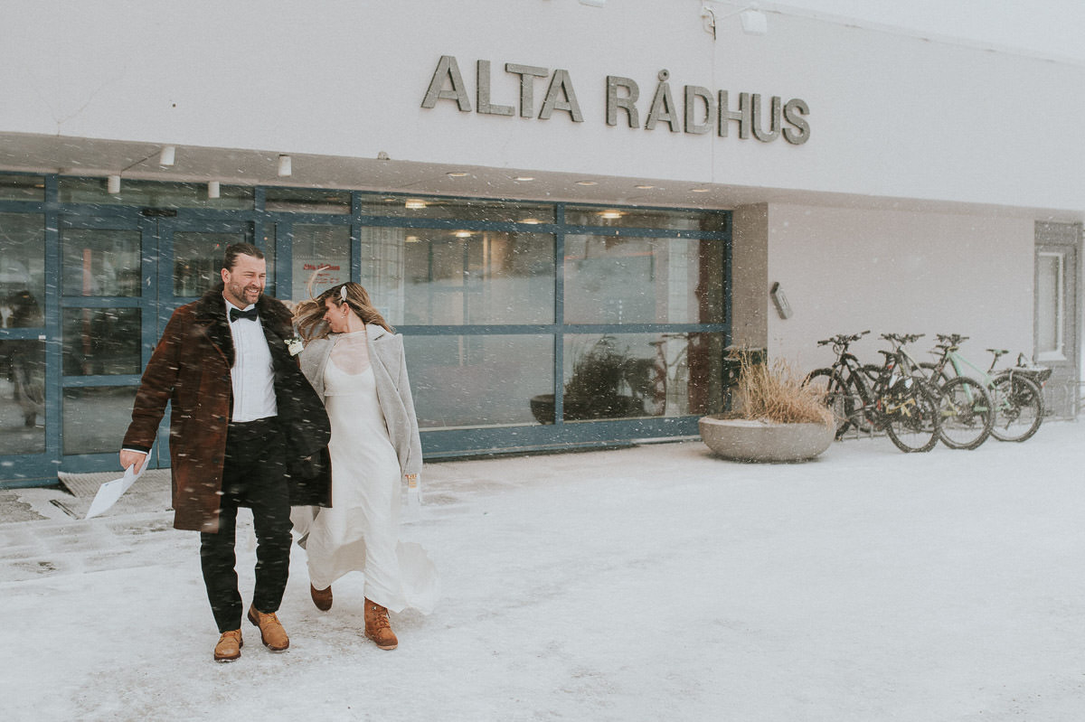 Bride and groom leaving Alta rådhus after signing their wedding certificates on their wedding ceremony