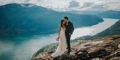 Fjord elopement in Norway - bride and groom on a mountaintop above Nordfjord in Loen Western Norway captured by elopement photographer TS Foto Design
