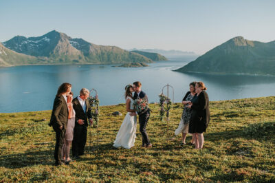 Intimate wedding ceremony under the midnight sun by the fjord in Norway