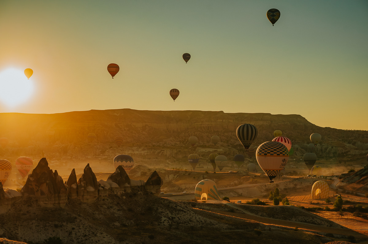 Stunning sunrise in Cappadocia Turkey with hundreds hot air balloons floating in the sky - captured by Turkey photographer TS Foto Design