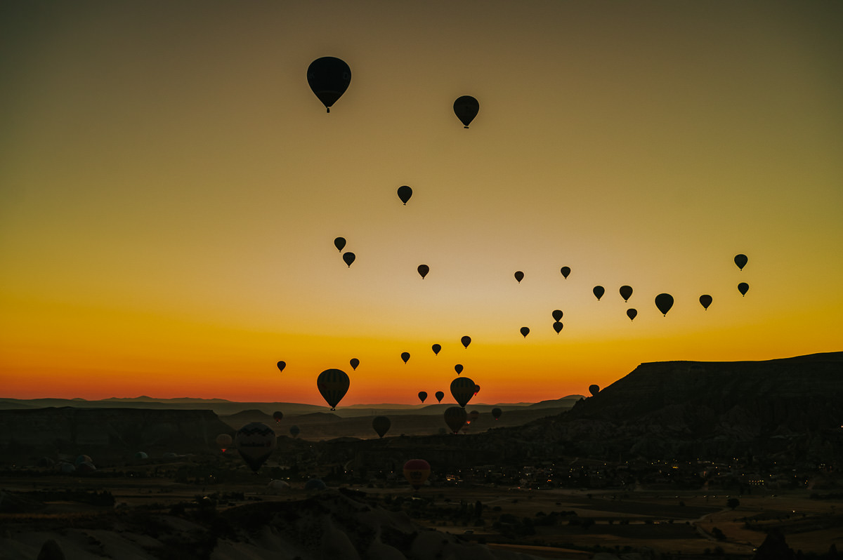 Gorgeous dawn photograph of hot air balloons before sunrise in Cappadocia Turkey 