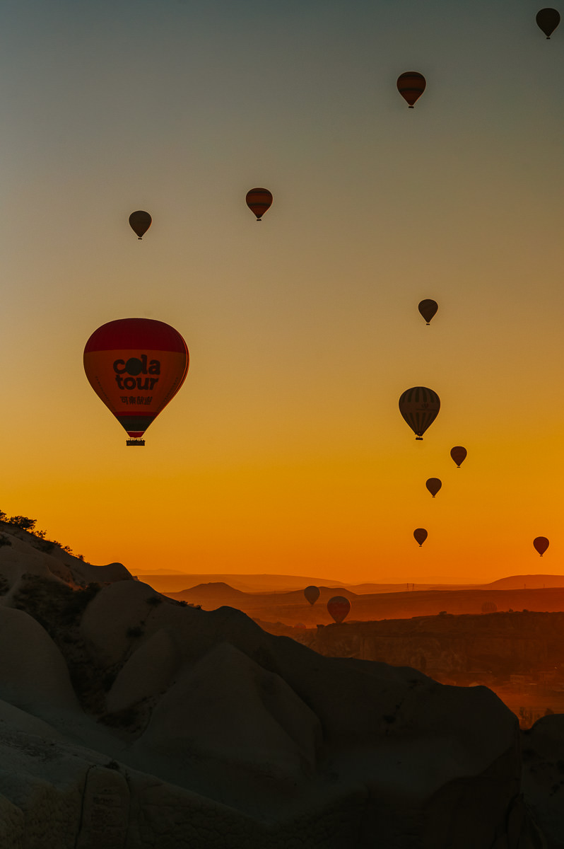 Stunning sunrise in Cappadocia Turkey with hundreds hot air balloons floating in the sky