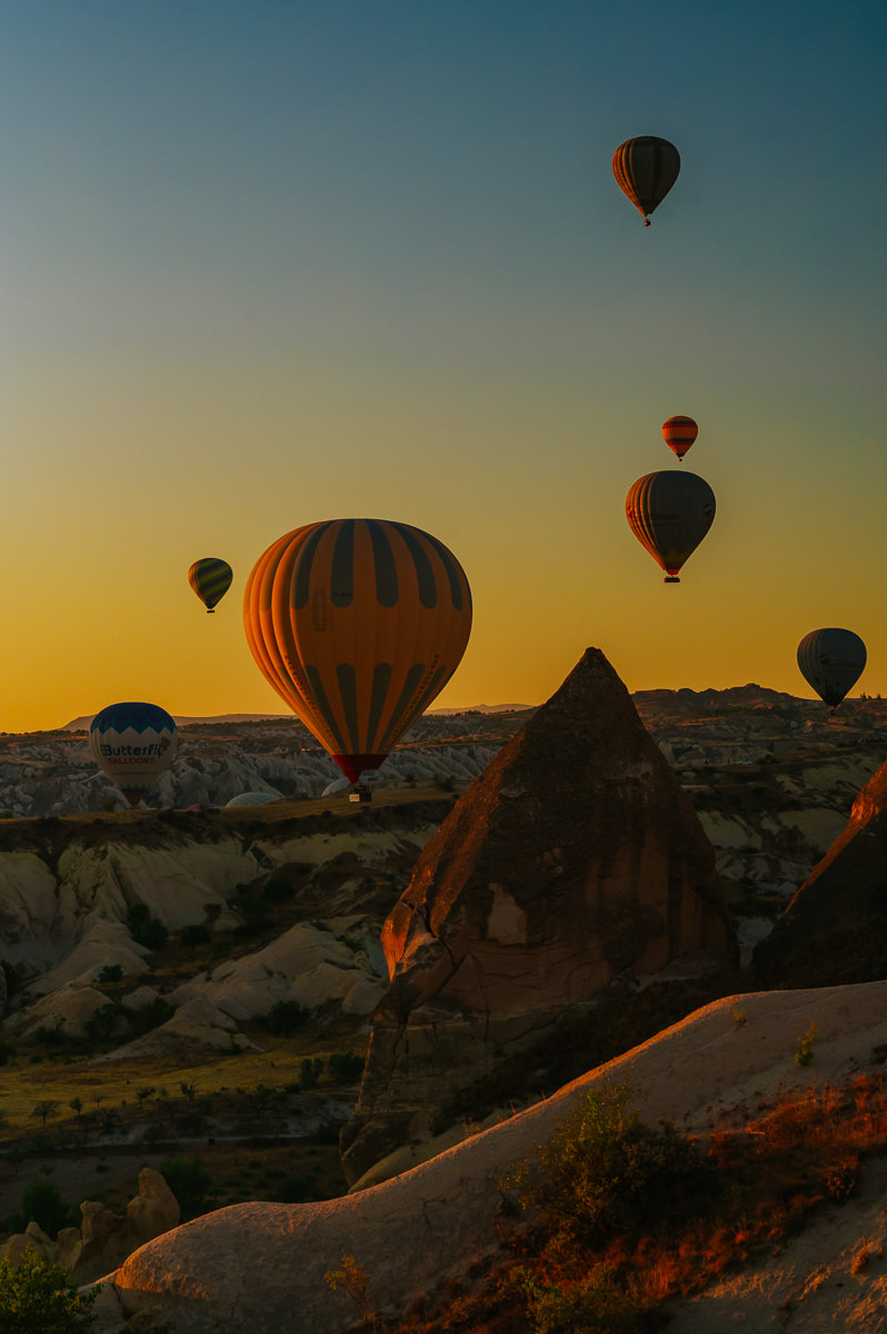 Stunning sunrise in Cappadocia Turkey with hundreds hot air balloons floating in the sky