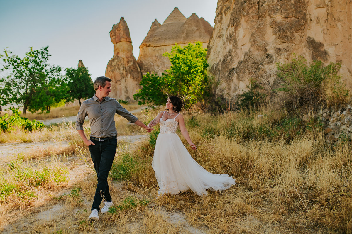 Bride and groom walking in Love Valley on the day of their Cappadocia elopement in Turkey