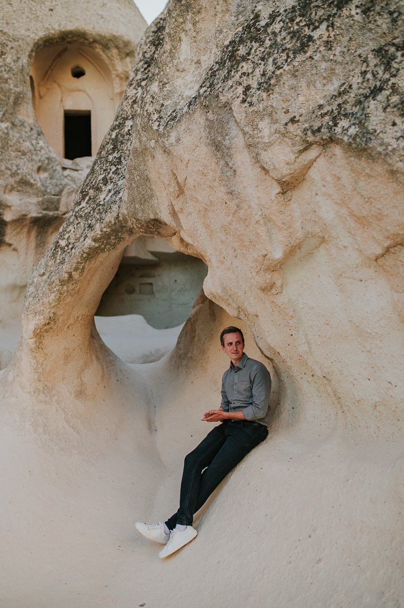 Groom among cool rock formations in Cappadocia 