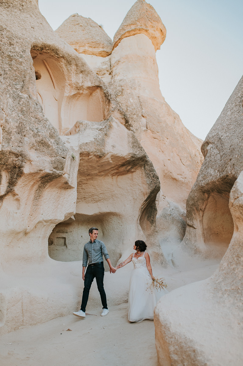Bride and groom walking in Love Valley on the day of their Cappadocia elopement in Turkey