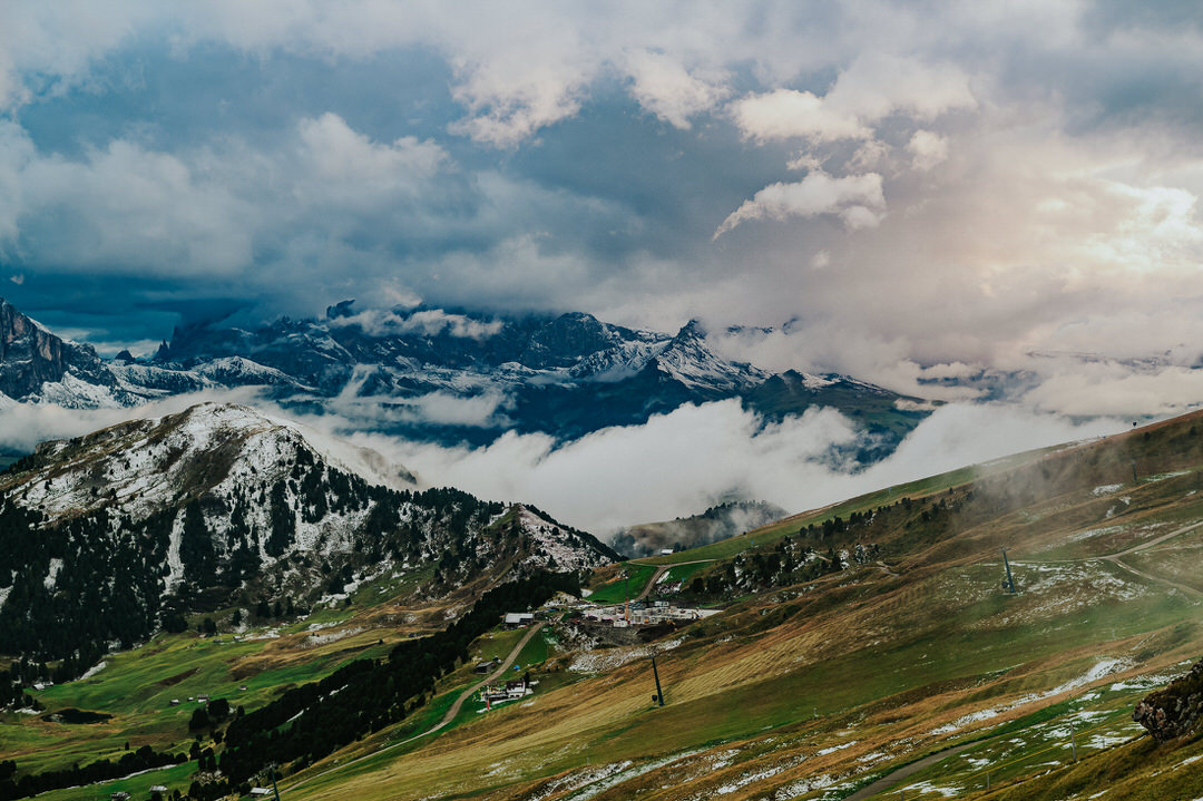 Landscape photograph of rolling clouds on a Seceda mountaintop in the Italian Dolomites