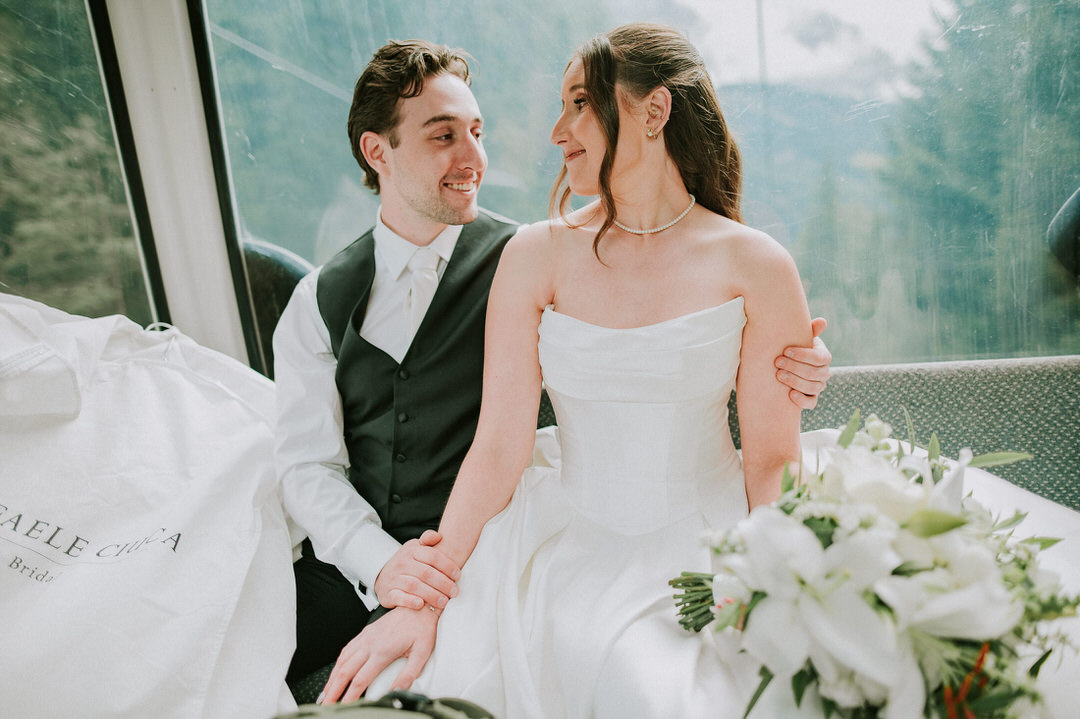 Bride and groom taking cable car in Col Raiser for the Seceda hike on the day of their adventure elopement in the Dolomites