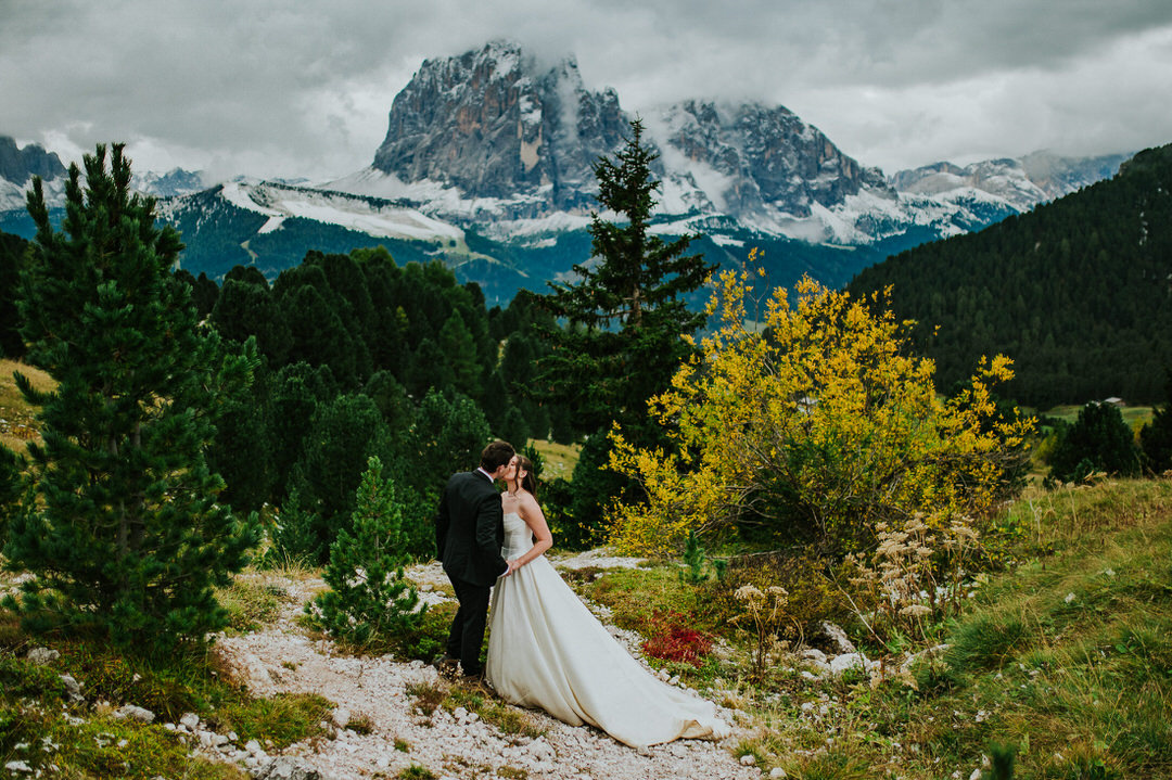 A Seceda hiking elopement in the Italian Dolomites - beautiful bride and groom walking among stunning landscapes - captured by Dolomites elopement photographer TS Foto Design
