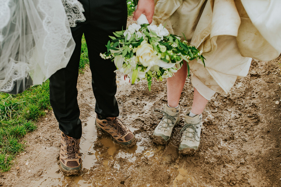 Muddy hiking boots on the day of an adventure Seceda elopement in the Italian Dolomites