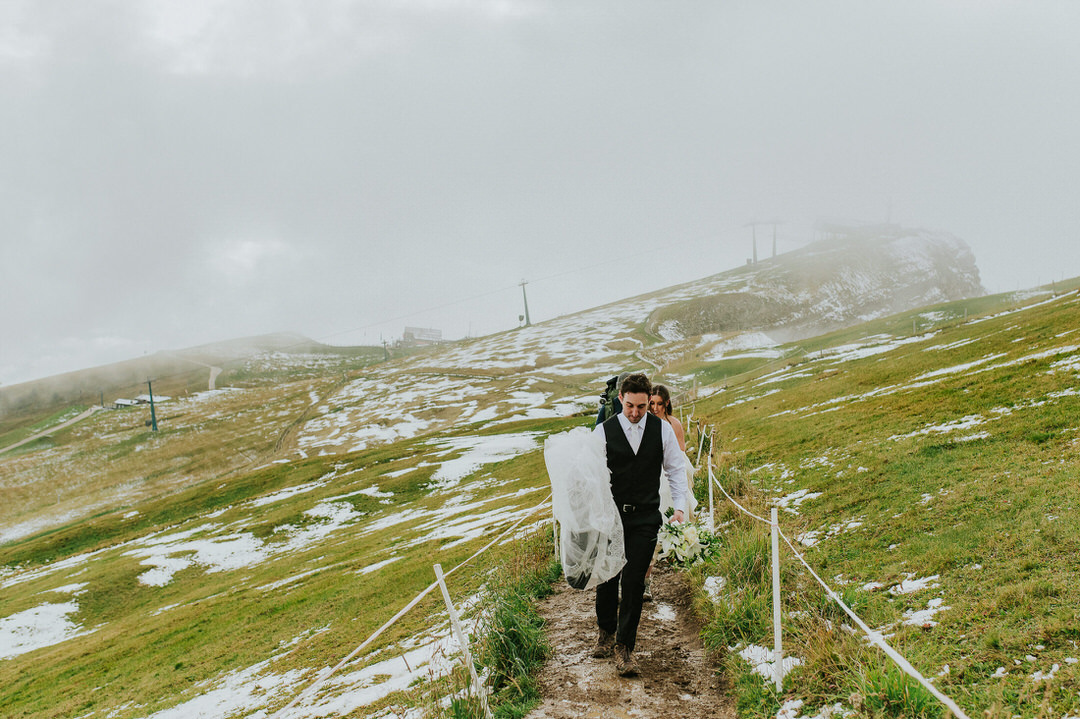 A Seceda elopement in the Italian Dolomites - beautiful bride and groom walking among stunning landscapes - captured by Dolomites elopement photographer TS Foto Design