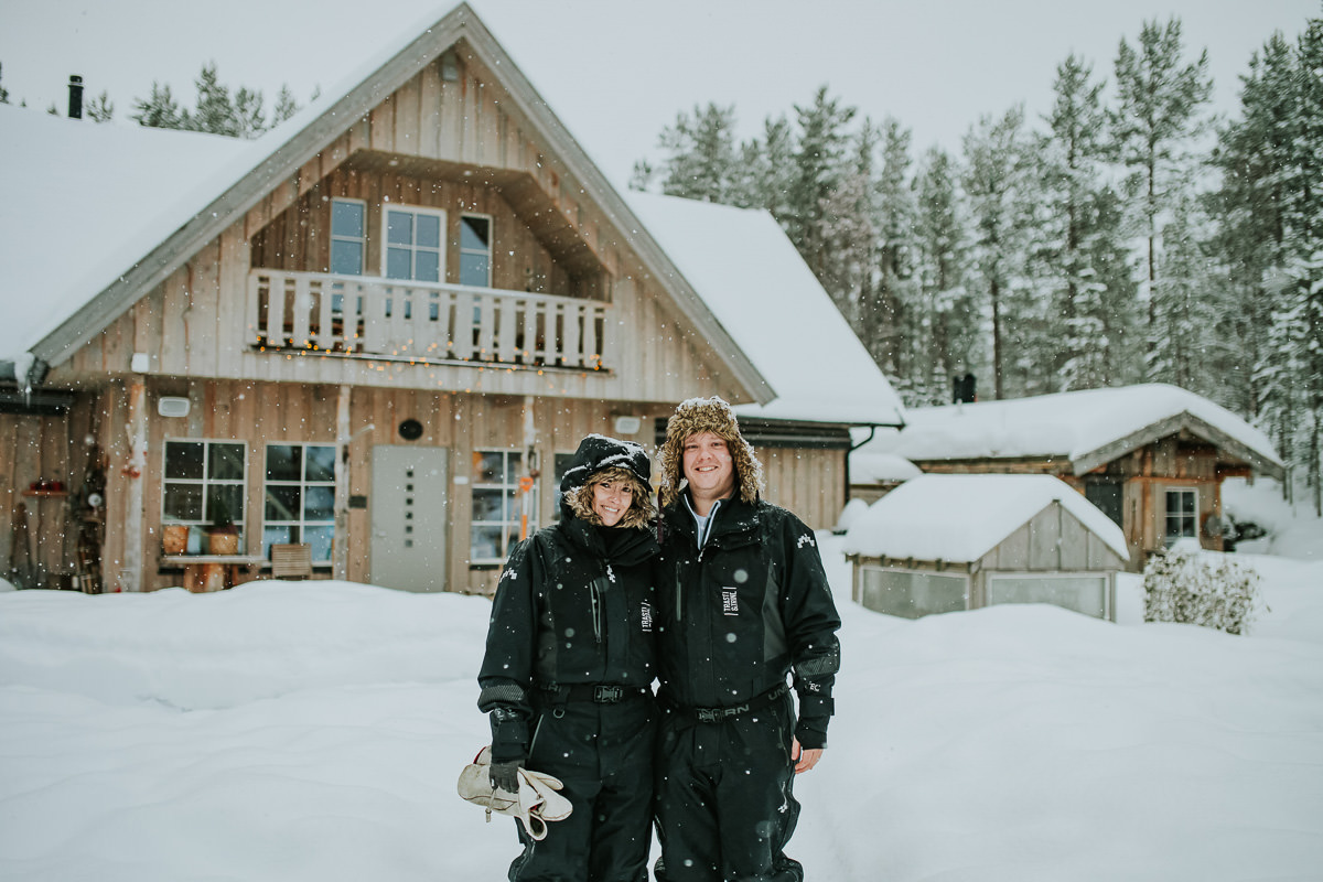 A cute couple under a beautiful snowfall in a small scandinavian village in Alta Norway
