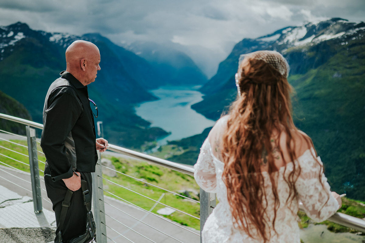Bride and groom overlooking the view to Lovatnet lake from Loen Skylift in Norway