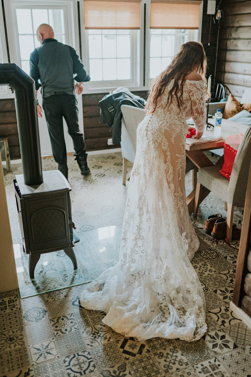 Bride and groom getting ready for their adventure elopement in a cabin Western Norway