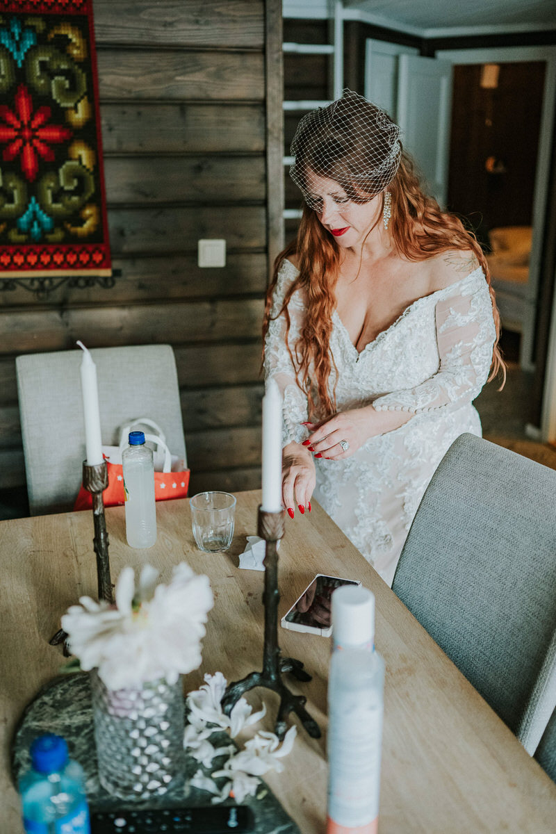 Bride and groom getting ready for their adventure elopement in a cabin Western Norway