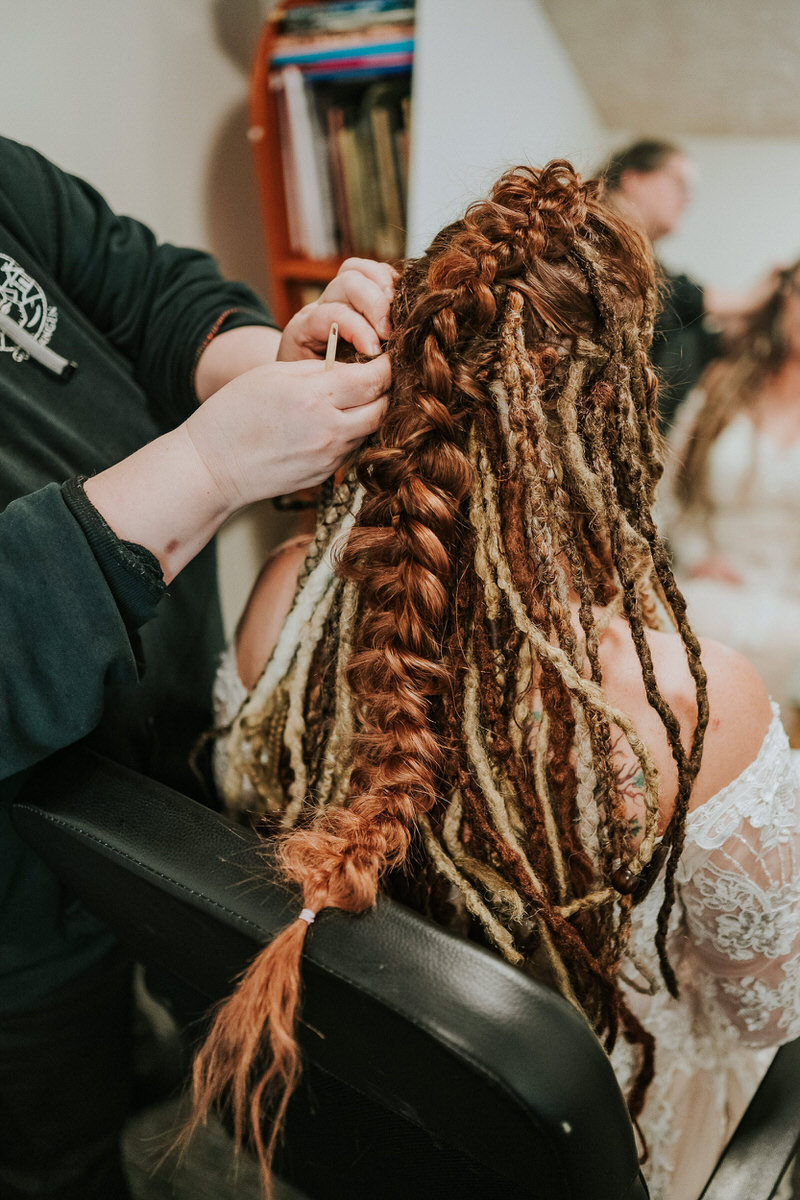 Bride getting her hair braided for her viking elopement in Norway