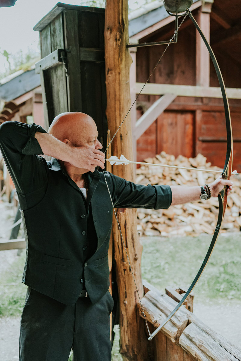 Groom shooting bow and arrow in  Gudvangen viking village